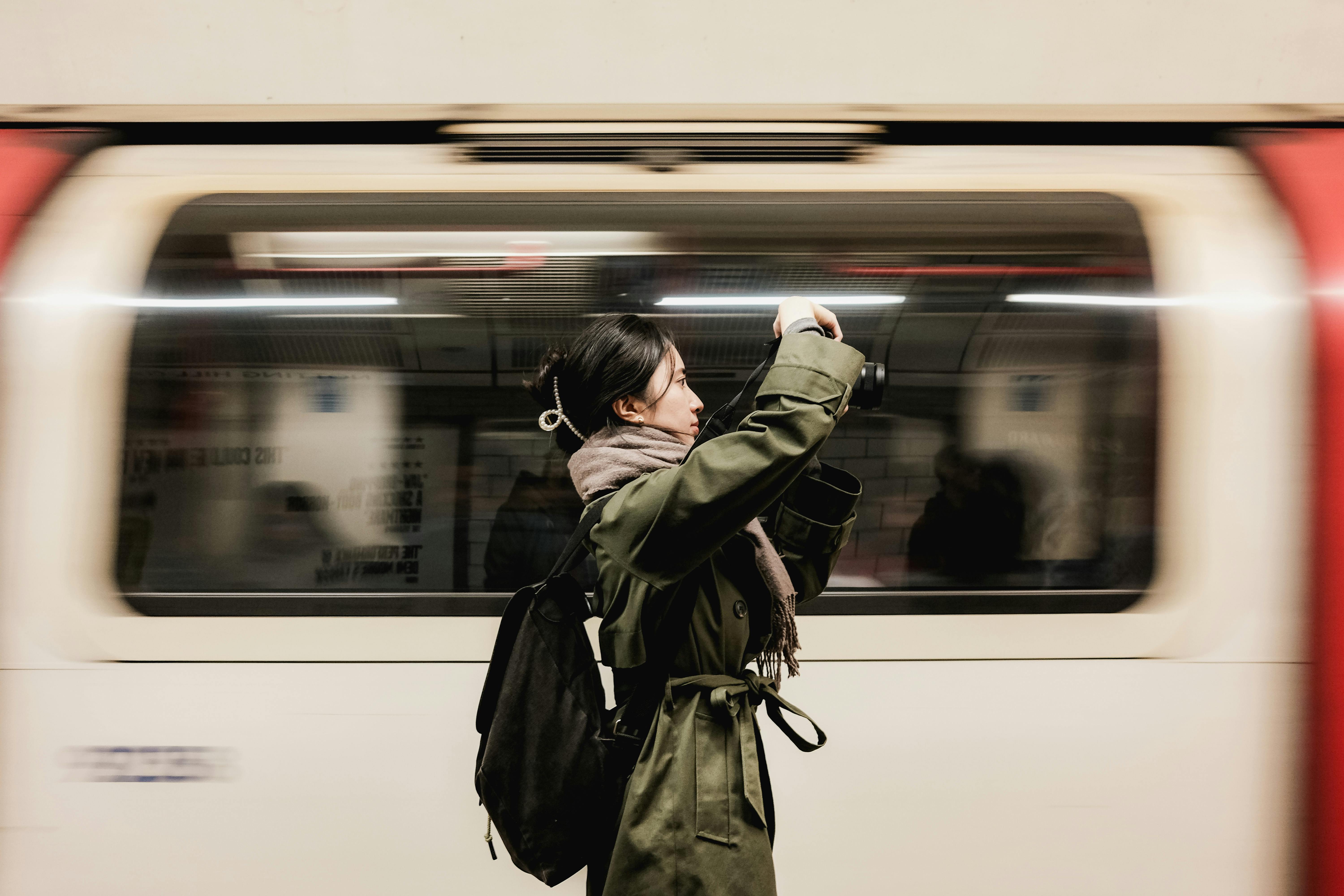 Person standing next to a moving metro.