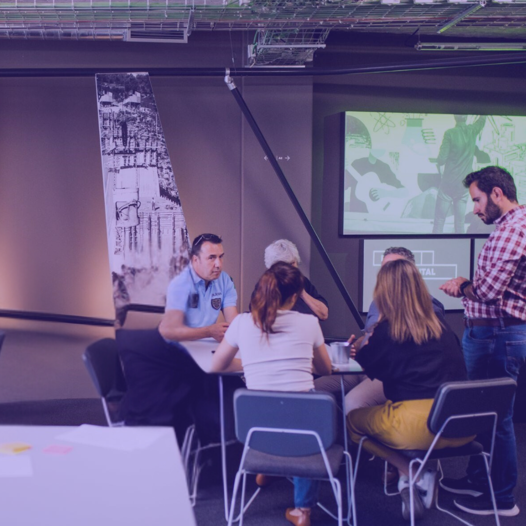 People sitting around a table in a conference room.